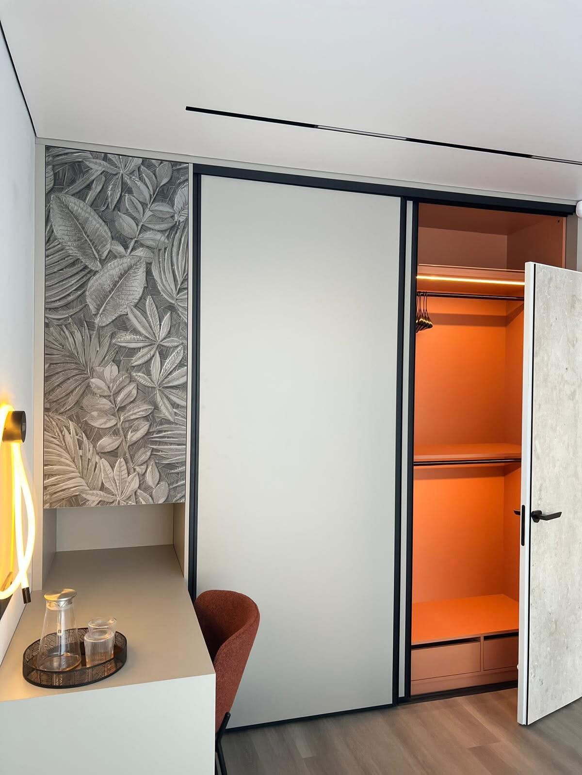 Interior with concealed door and illuminated wardrobe